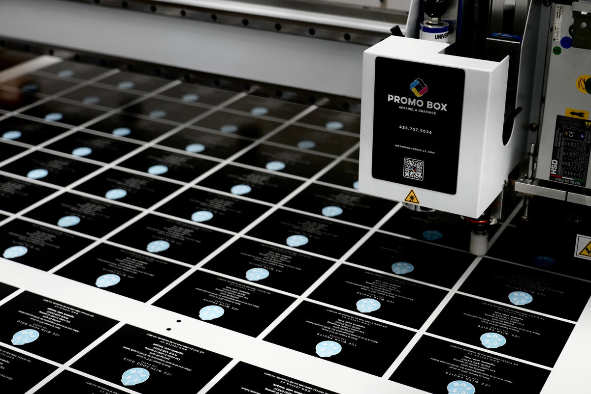 Promo Box flatbed cutter contour cutting a printed sheet in the Everett shop